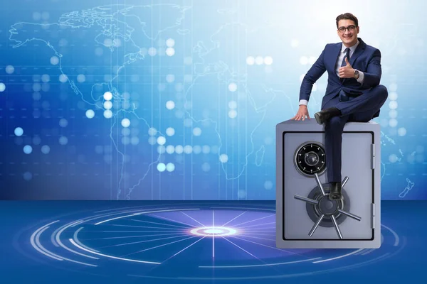 Businessman sitting on top of safe — Stock Photo, Image