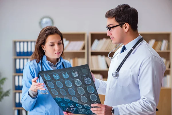 Jovem médico olhando para tomografia computadorizada imagem de raios-x — Fotografia de Stock