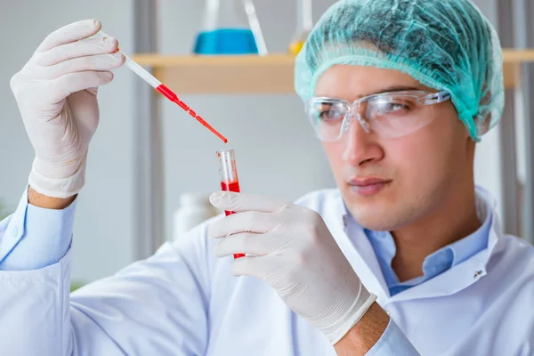Jonge arts werkt aan bloedonderzoek in het lab ziekenhuis — Stockfoto