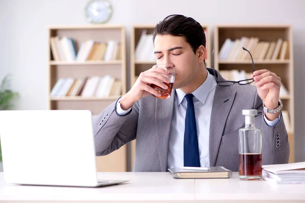 Young businessman drinking from stress — Stock Photo, Image