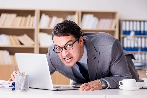 Angry businessman with too much work in office