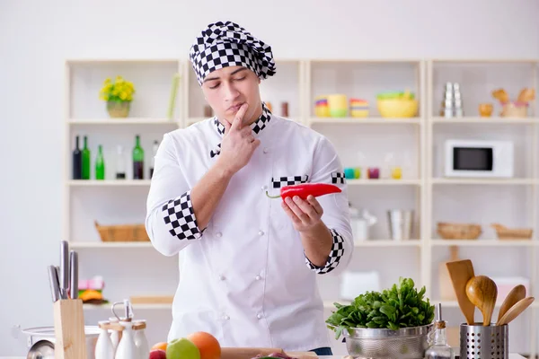 Young male cook working in the kitchen — Stock Photo, Image