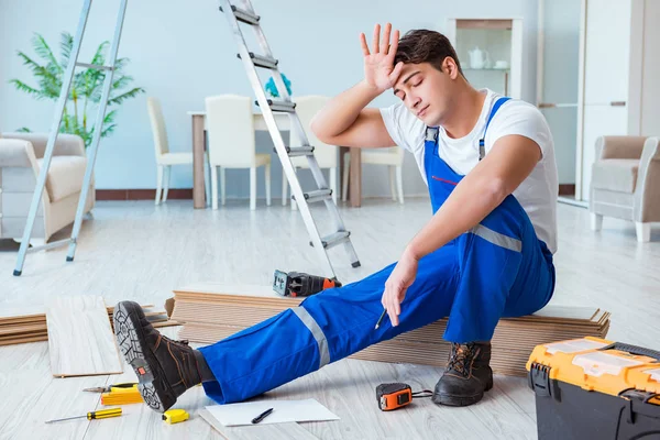 Reparador que pone suelo laminado en casa — Foto de Stock