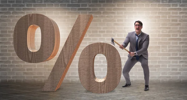 Angry man with axe axing the percentage sign — Stock Photo, Image
