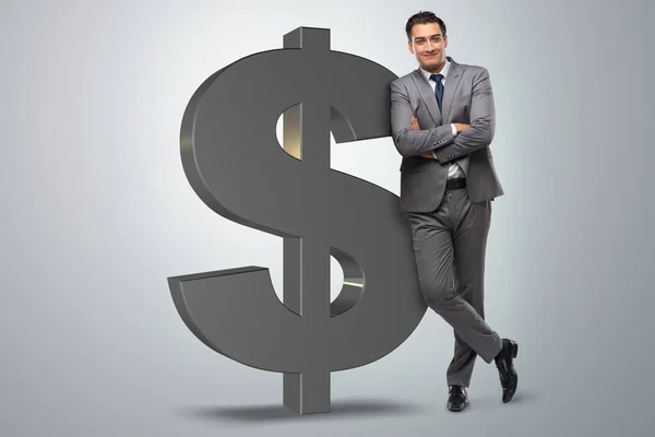Бизнесмен рядом со знаком доллара — стоковое фото
