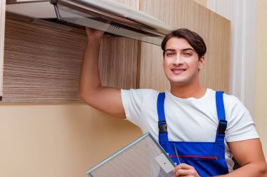 Young man working with kitchen equipment clipart