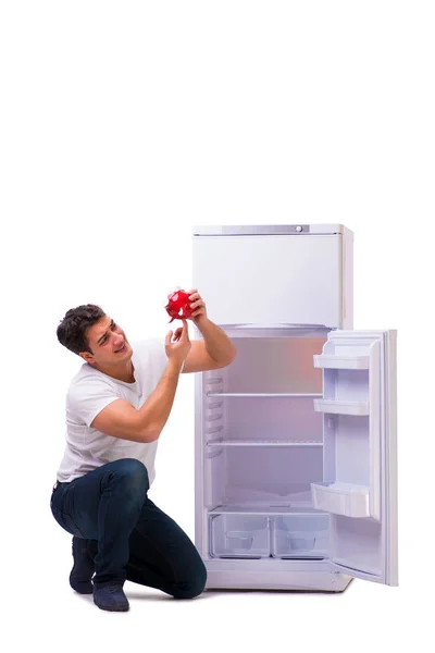 Hungry man looking for money to fill the fridge — Stock Photo, Image