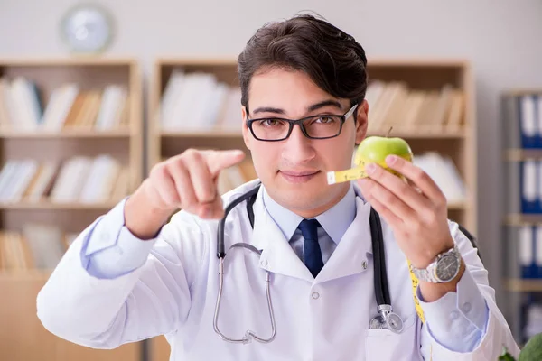 Doctor in dieting concept with fruits and vegetables