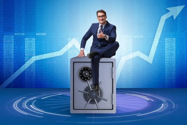 Businessman sitting on top of safe — Stock Photo, Image