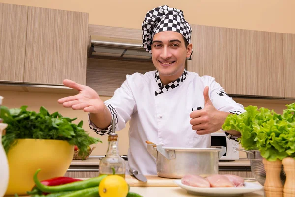 Young chef working in the kitchen — Stock Photo, Image