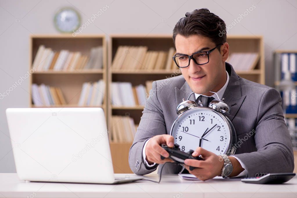 Businessman playing computer games at work office
