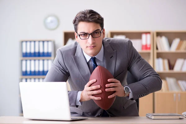 Businessman with american football in office — Stock Photo, Image