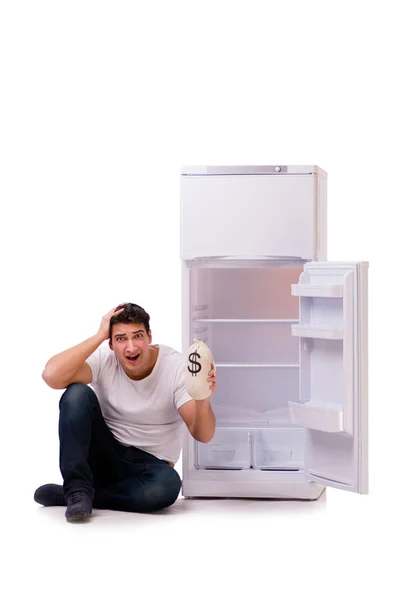 Hungry man looking for money to fill the fridge — Stock Photo, Image