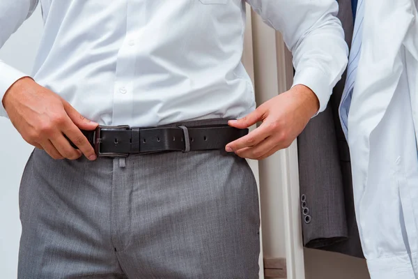 Businessman dressing up for work