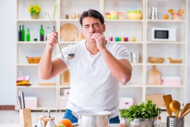 Genç aşçı mutfakta çalışıyor.