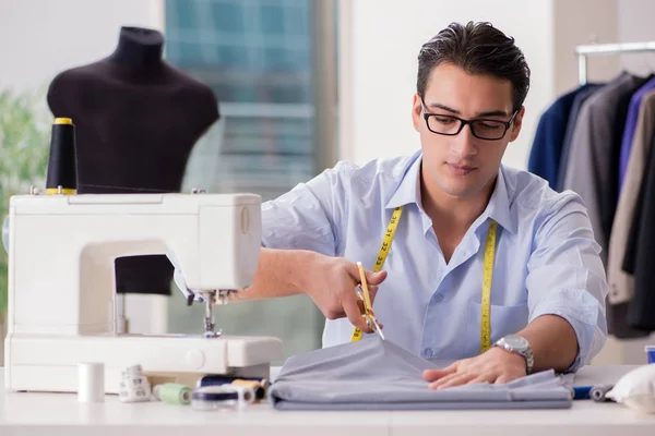 Joven sastre trabajando en ropa nueva —  Fotos de Stock