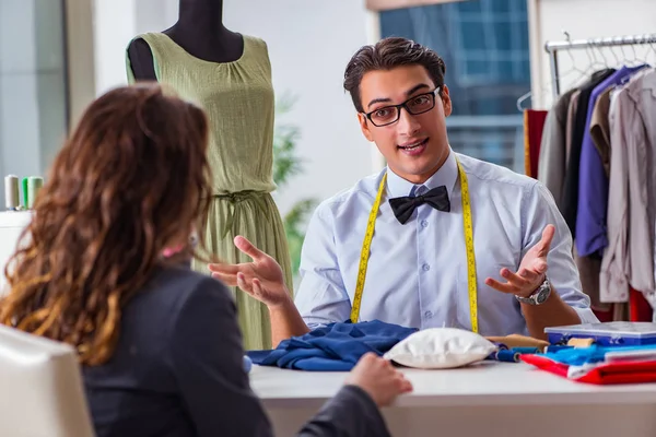 Young man tailor working with female client — Stock Photo, Image