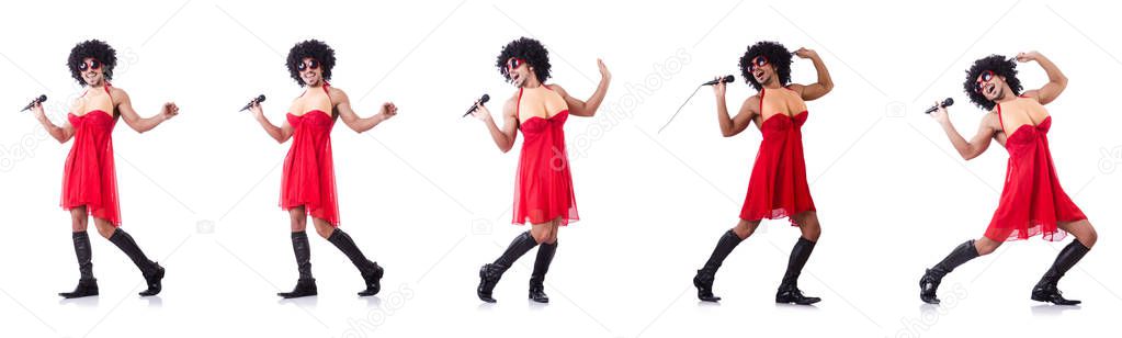 Man in female clothing singing with mic