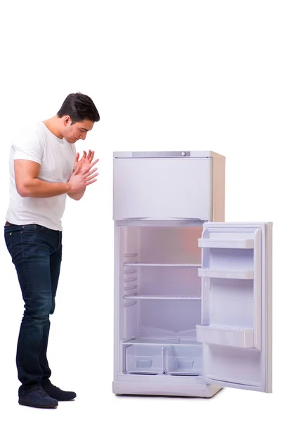 Man looking for food in empty fridge — Stock Photo, Image