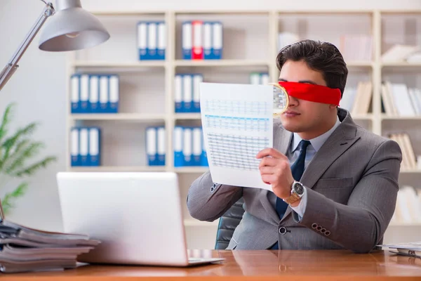 Blindfold businessman sitting at desk in office — Stock Photo, Image