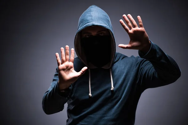 Man wearing hood in dark room — Stock Photo, Image