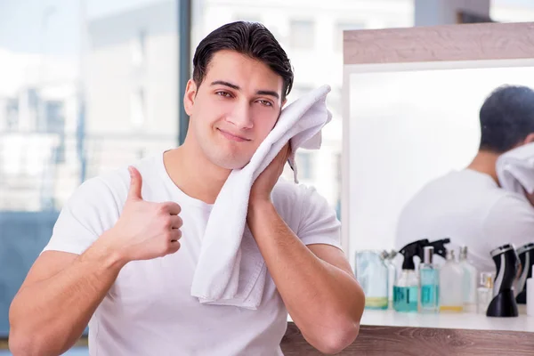 Young handsome man applying face cream — Stock Photo, Image
