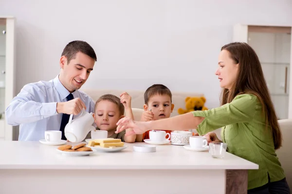 Família feliz tomando café da manhã juntos em casa — Fotografia de Stock