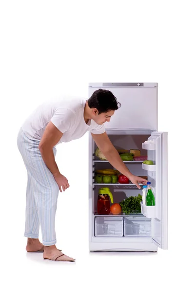 Man next to fridge full of food — Stock Photo, Image