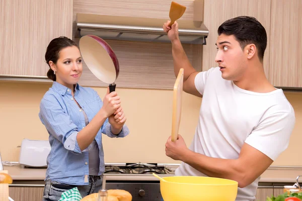 Young family doing funny fight at kitchen — Stock Photo, Image