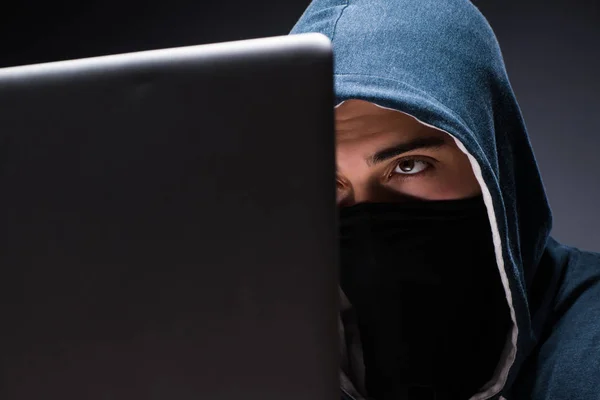 Computer hacker working in dark room — Stock Photo, Image