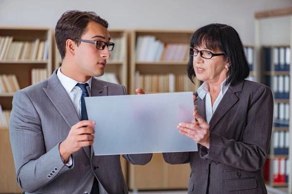 Businesspeople discussing business results on tablet computer