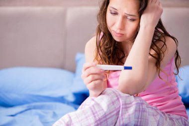 Woman upset with pregnancy test results clipart