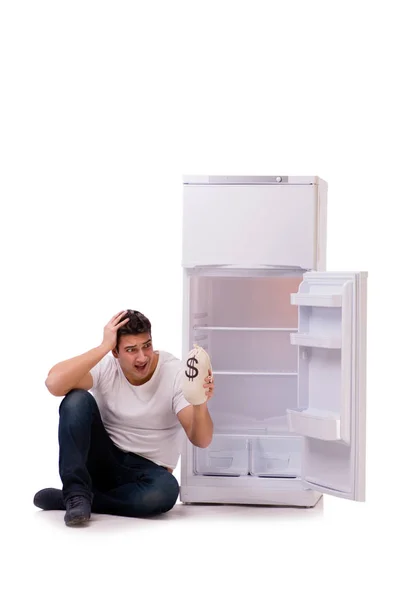 Hungry man looking for money to fill the fridge — Stock Photo, Image