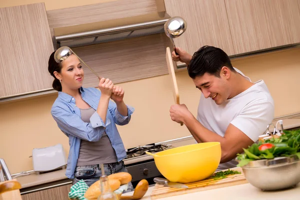 Jovem família fazendo luta engraçada na cozinha — Fotografia de Stock