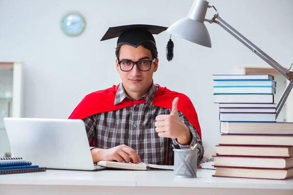 Super hero student with books studying for exams — Stock Photo, Image