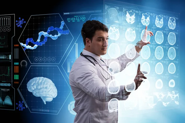 Erkek doktor MRI taramasının röntgenini çekiyor.