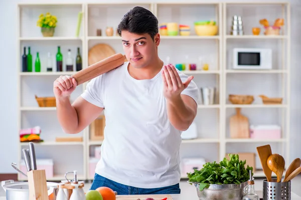 Jonge mannelijke kok werkt in de keuken — Stockfoto