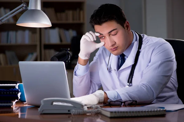 Młody lekarz pracujący do późna w biurze — Zdjęcie stockowe