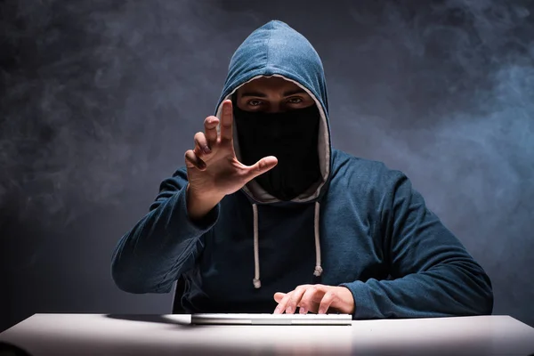 Computer hacker working in dark room — Stock Photo, Image