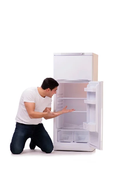 Man looking for food in empty fridge — Stock Photo, Image