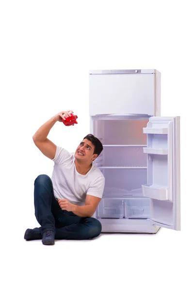 Hungry man looking for money to fill the fridge — Stock Photo, Image