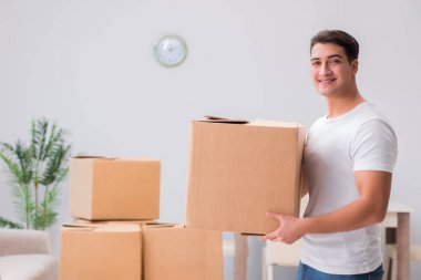 Evde kutu taşıyan bir adam.