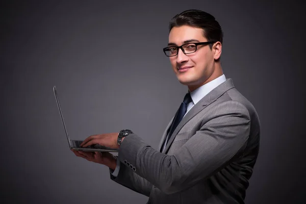 Handsome businessman working on laptop computer — Stock Photo, Image