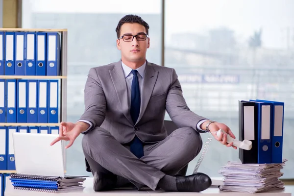 Businessman meditating in the office — Stock Photo, Image