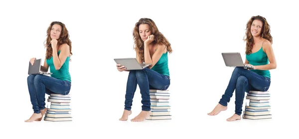 Student with netbook sitting on books — Stock Photo, Image