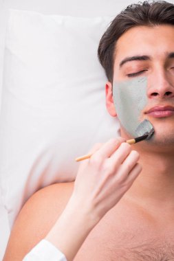 Kaplıca masaj konseptinde yakışıklı bir adam.