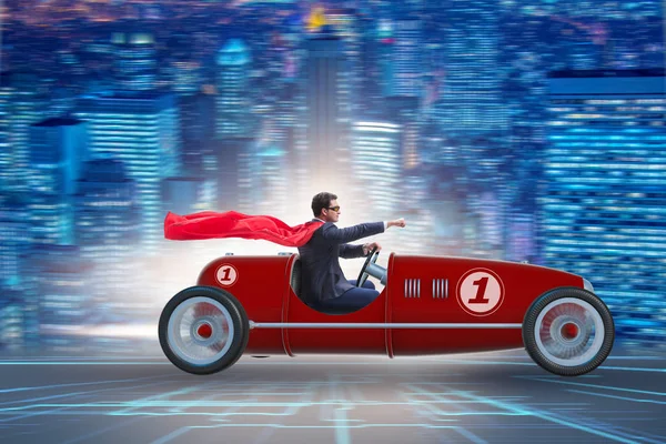 Superhero businessman driving vintage roadster — Stock Photo, Image