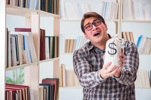 Young student in expensive textbooks concept — Stock Photo, Image