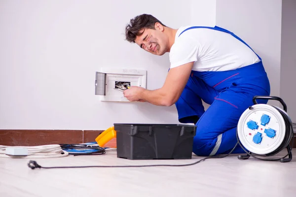 Funny Man doing electrical repairs at home