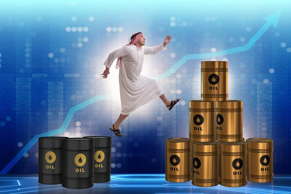 Арабский бизнесмен прыгает с нефтяных баррелей — стоковое фото